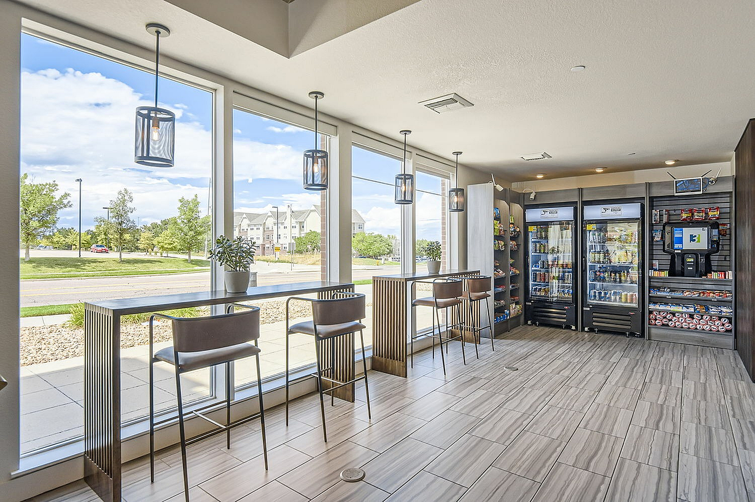 Modern snack bar with large windows, sleek seating, and stocked vending area, offering a bright and inviting atmosphere.