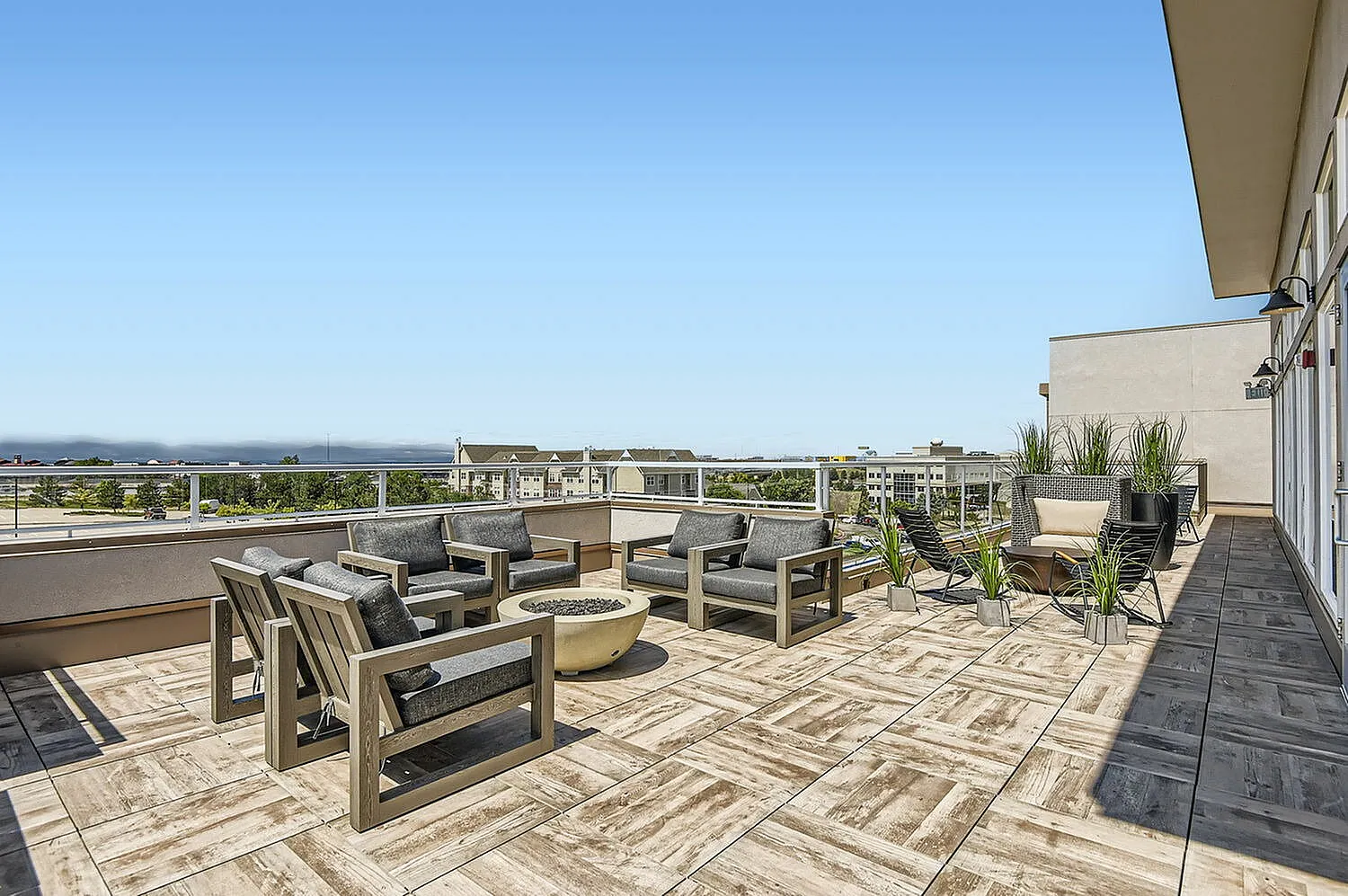 Expansive rooftop terrace with modern outdoor furniture, offering scenic city views and a perfect setting for relaxation and entertainment.