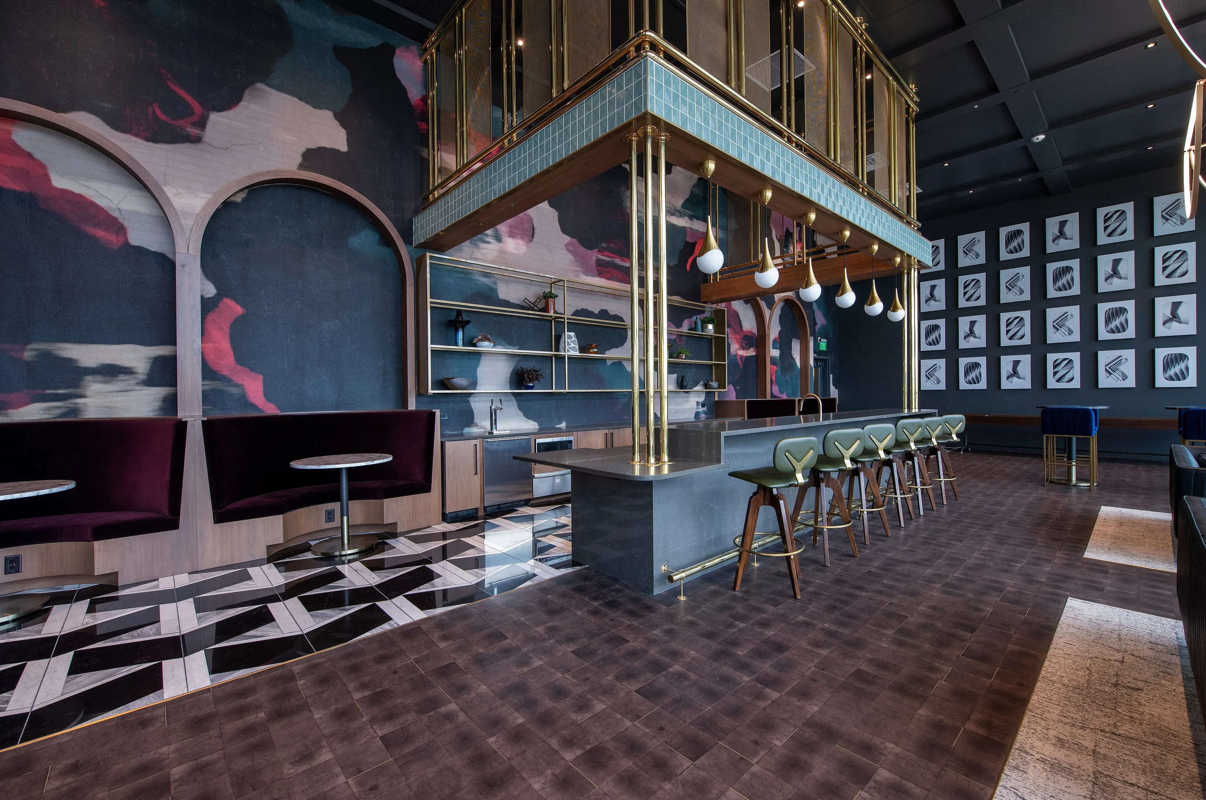 Chic modern lounge featuring bold abstract artwork, plush seating, stylish bar area, and sleek lighting.