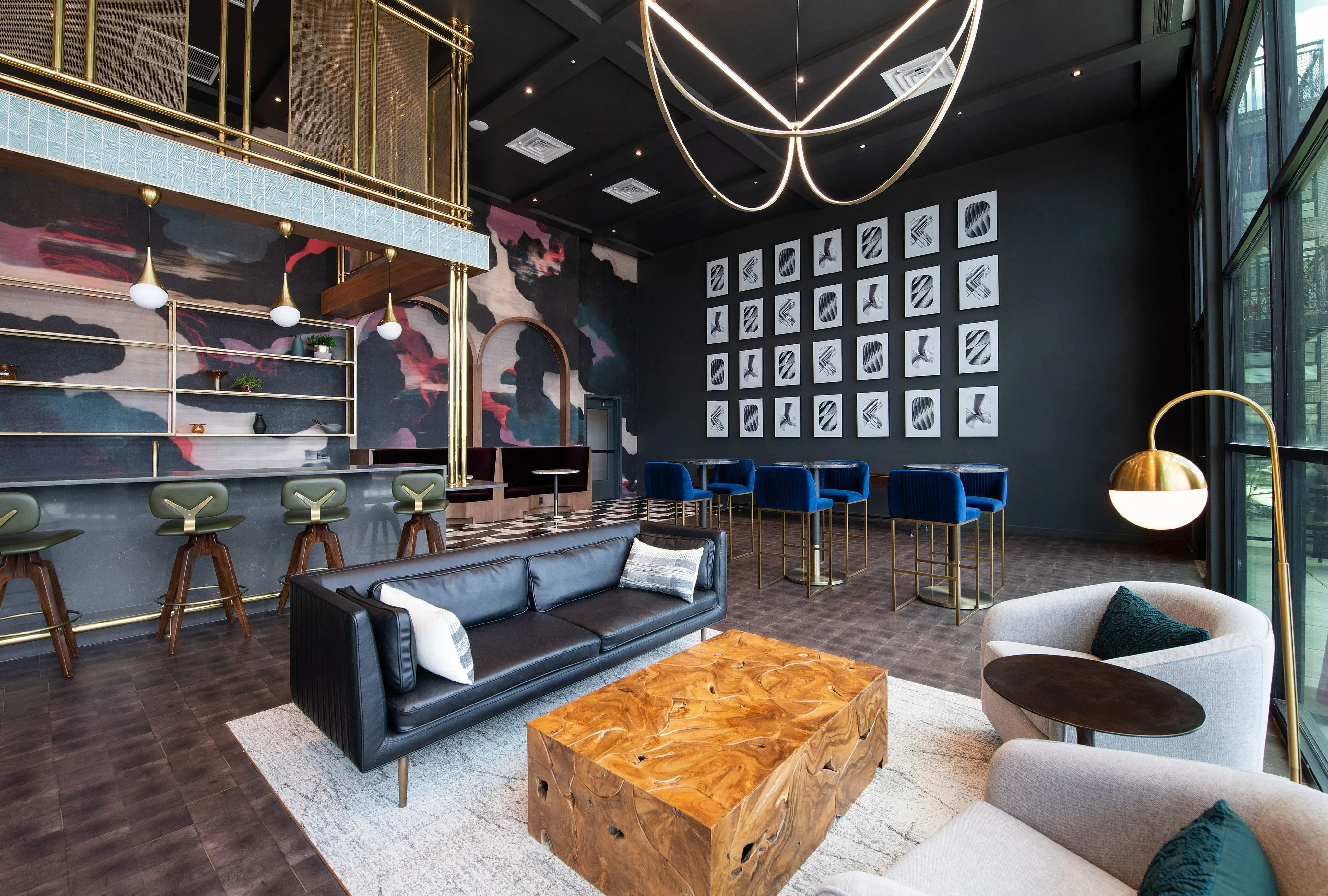 Chic modern lounge with artistic wall decor, stylish bar seating, and luxurious lighting for a sophisticated ambiance.