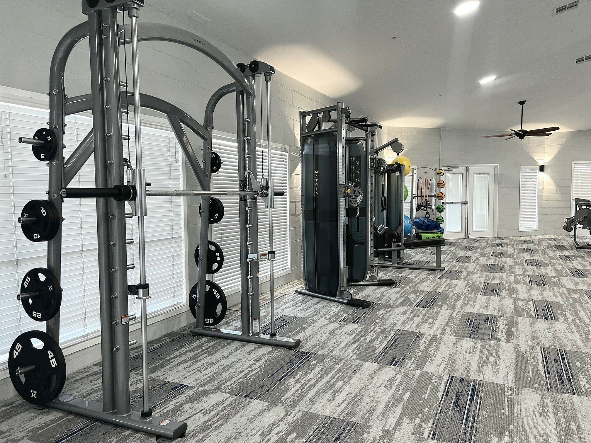 Modern fitness center featuring state-of-the-art weight machines and vibrant workout equipment in a well-lit, spacious room.