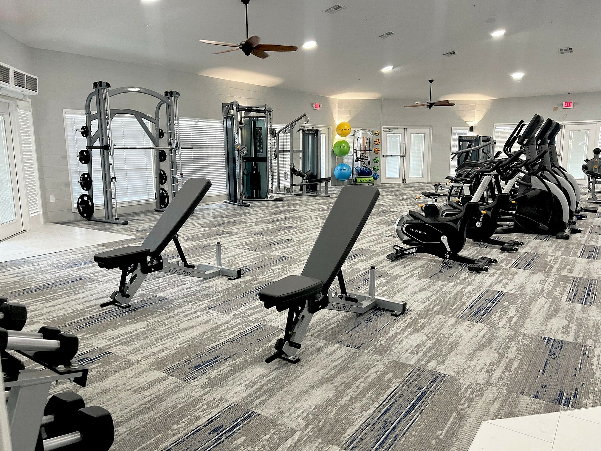 Modern gym with state-of-the-art equipment, bright lighting, and a spacious layout for a premium fitness experience.