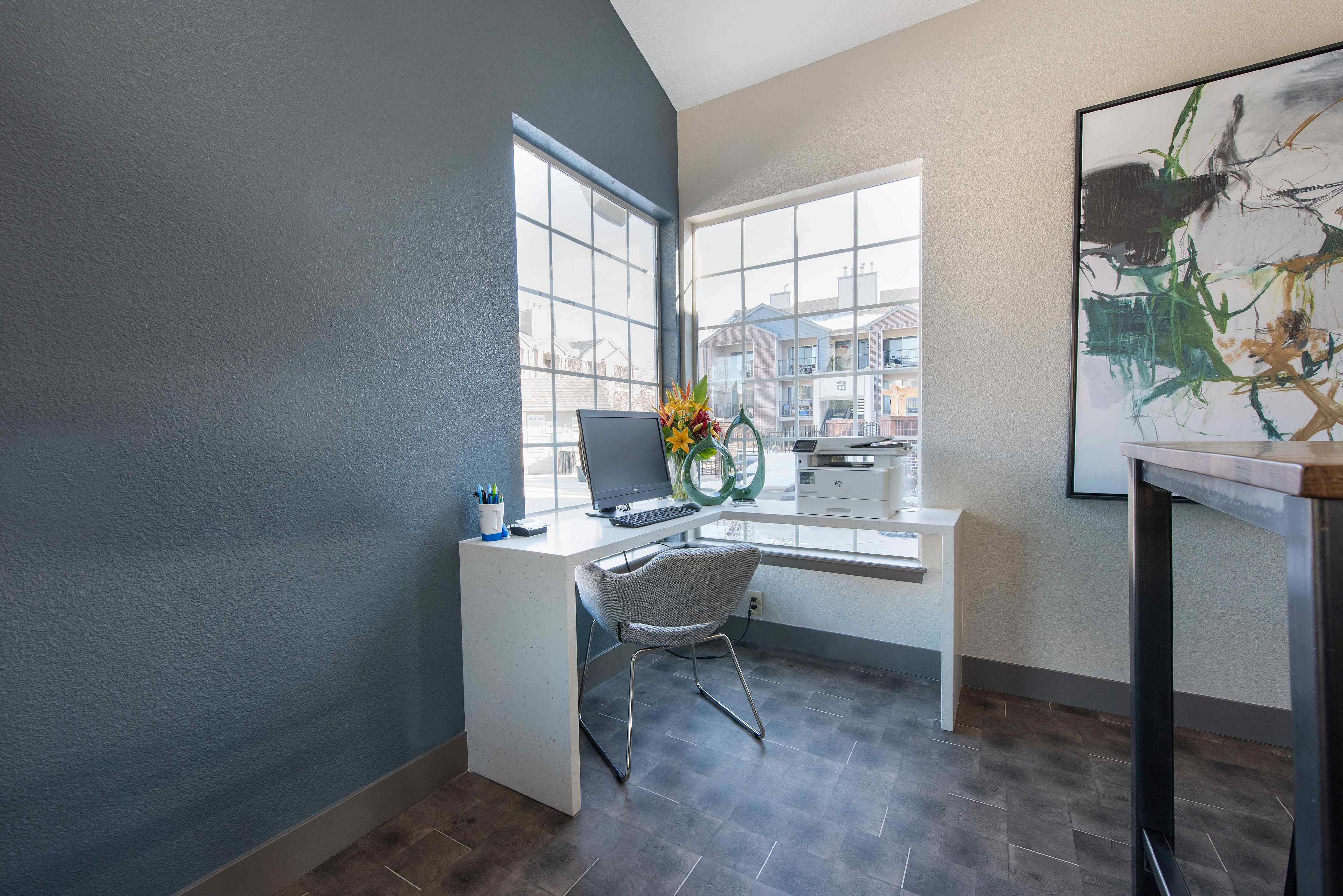 Bright and modern home office with a sleek desk, comfortable chair, and large windows offering ample natural light.
