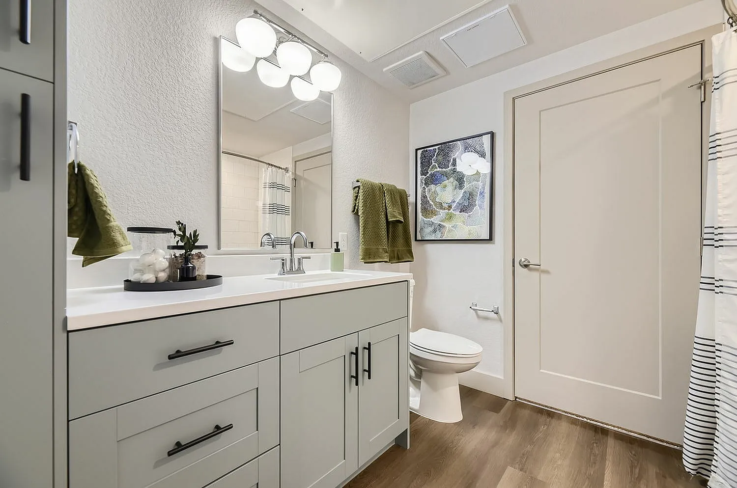 Contemporary bathroom with stylish vanity, elegant wall art, and soft lighting for a modern touch.