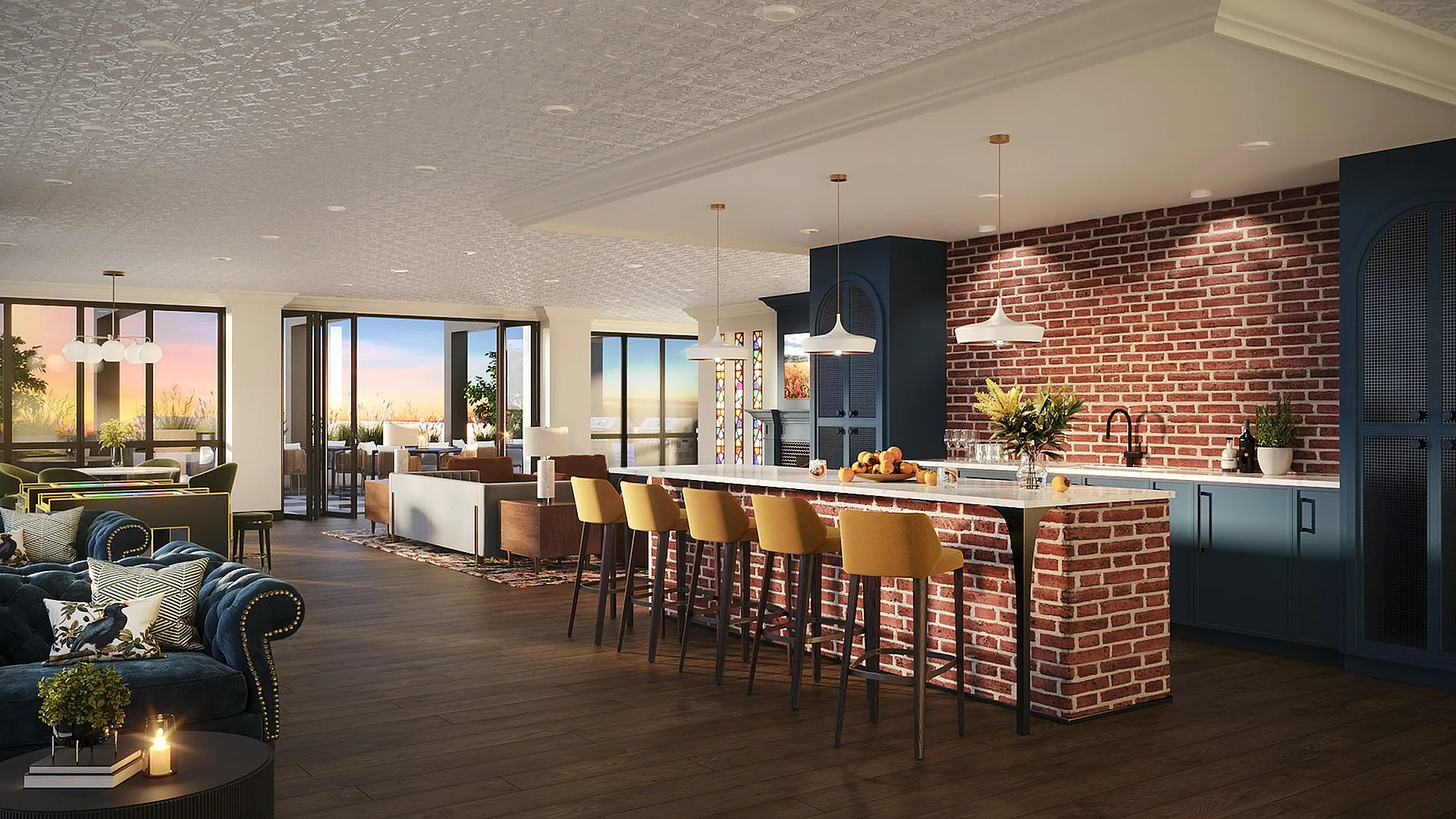 Elegant open-plan kitchen and living space with a stylish brick wall, cozy seating, and panoramic sunset views from large windows.