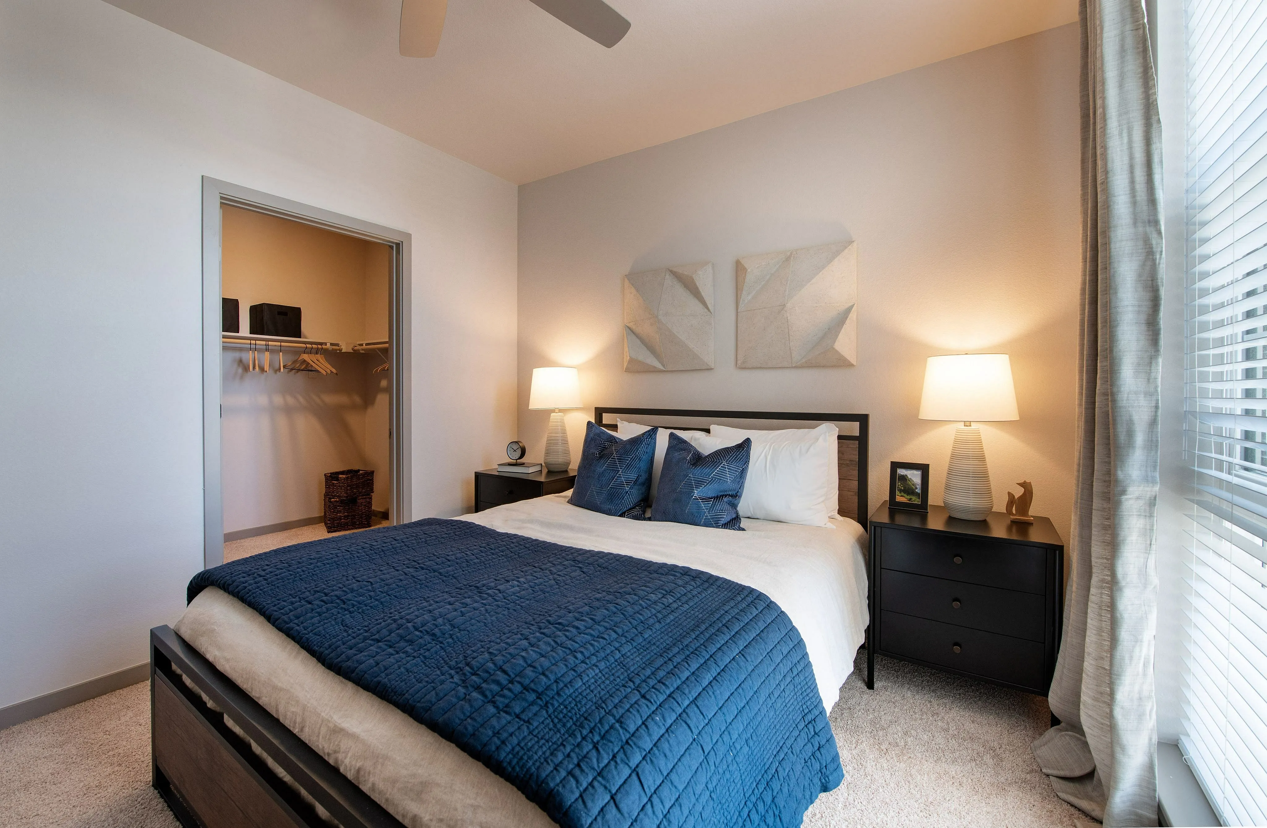 Cozy and inviting bedroom with modern decor, featuring a plush bed, stylish nightstands, and ample natural light from large windows.