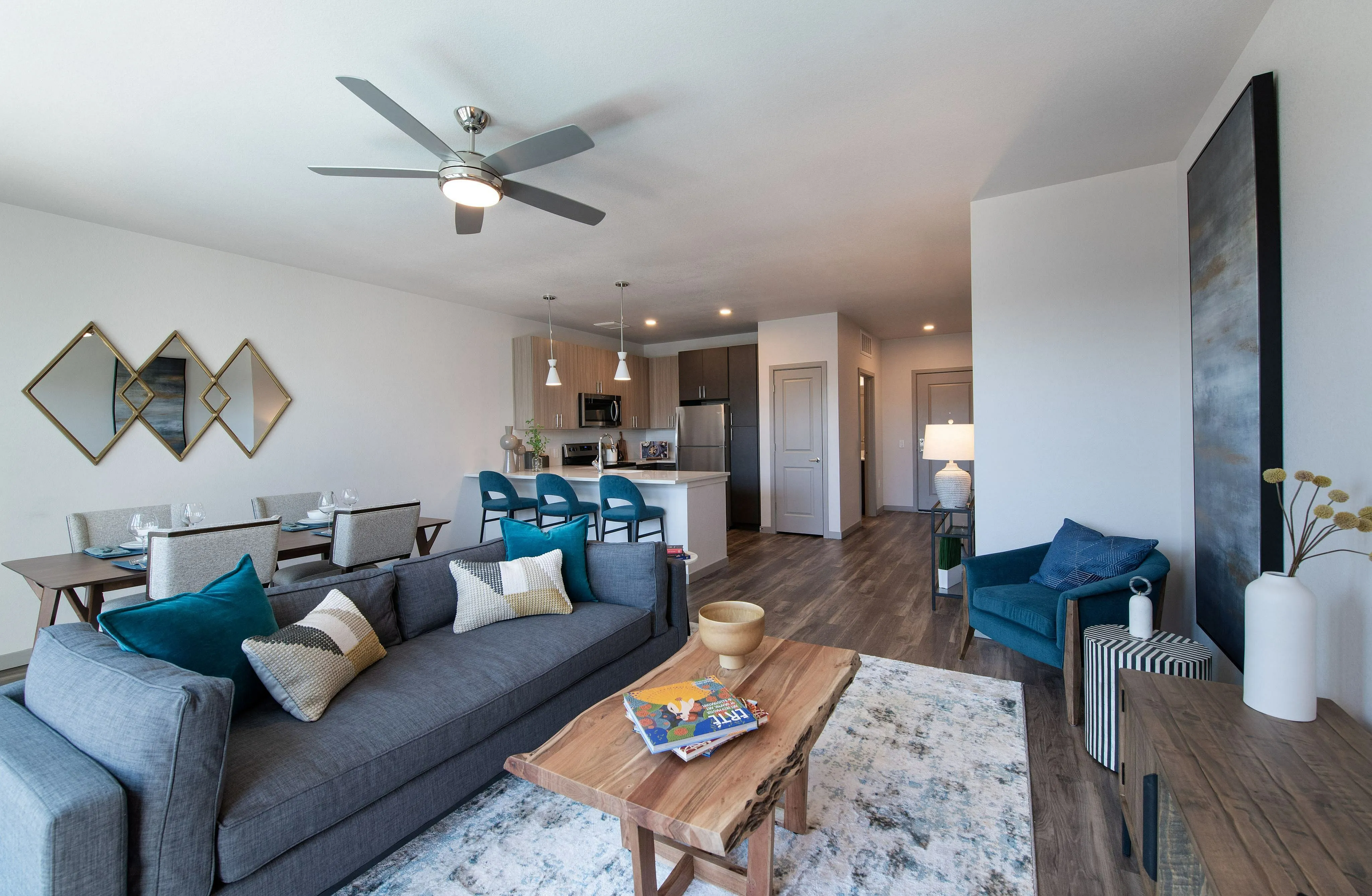 Modern open-concept living space with elegant dining area, stylish kitchen, and cozy seating with vibrant decor.