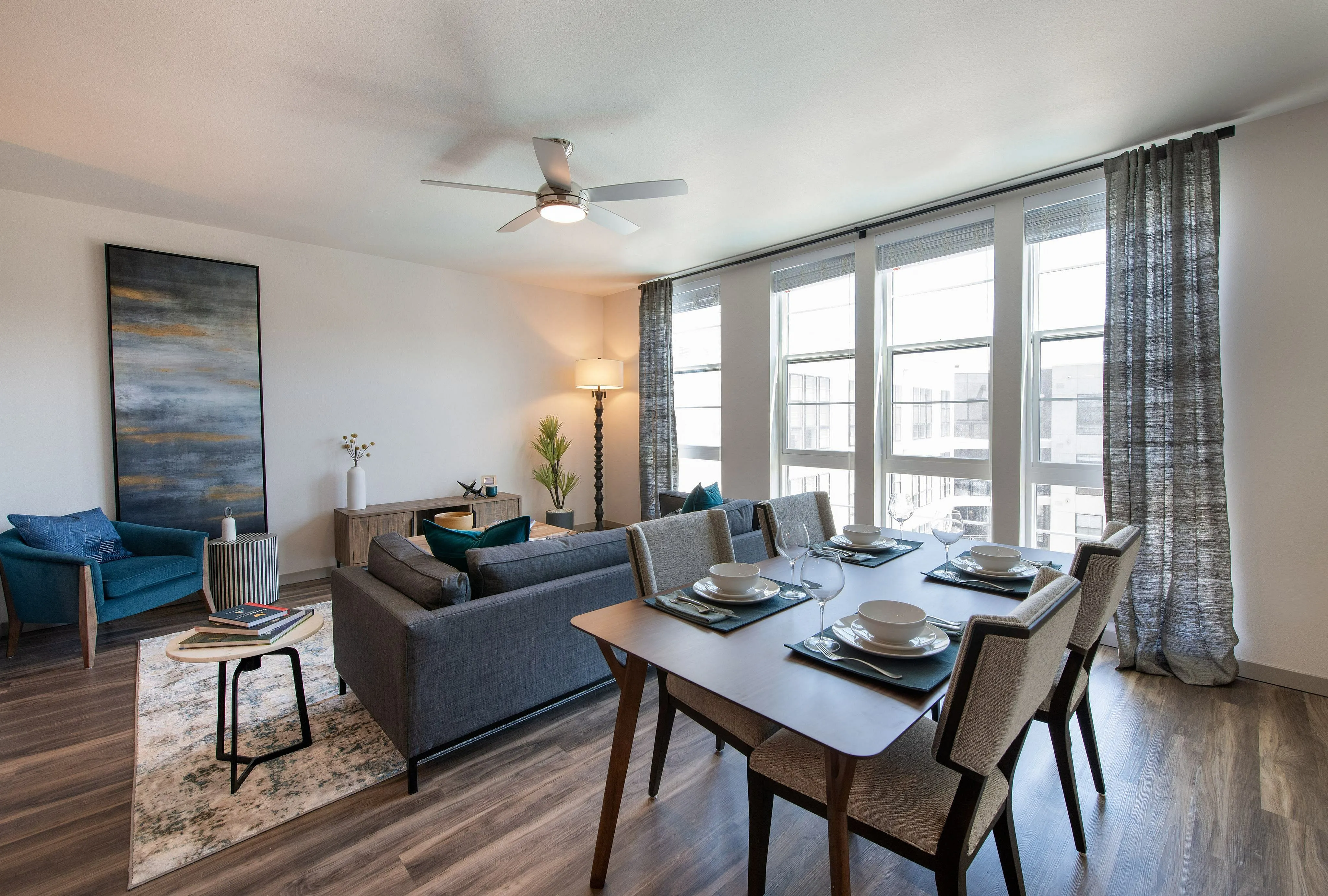 Contemporary living and dining area with stylish decor, featuring large windows, elegant furniture, and abundant natural light.