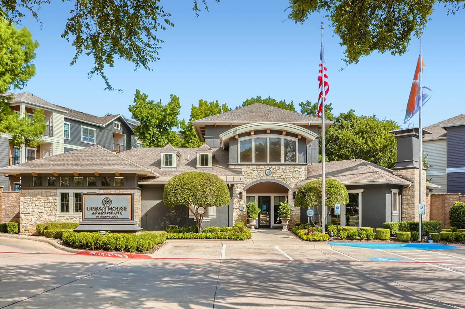 Elegant Urban House Apartments showcasing a modern exterior with lush landscaping, inviting entrance, and charming architectural details.