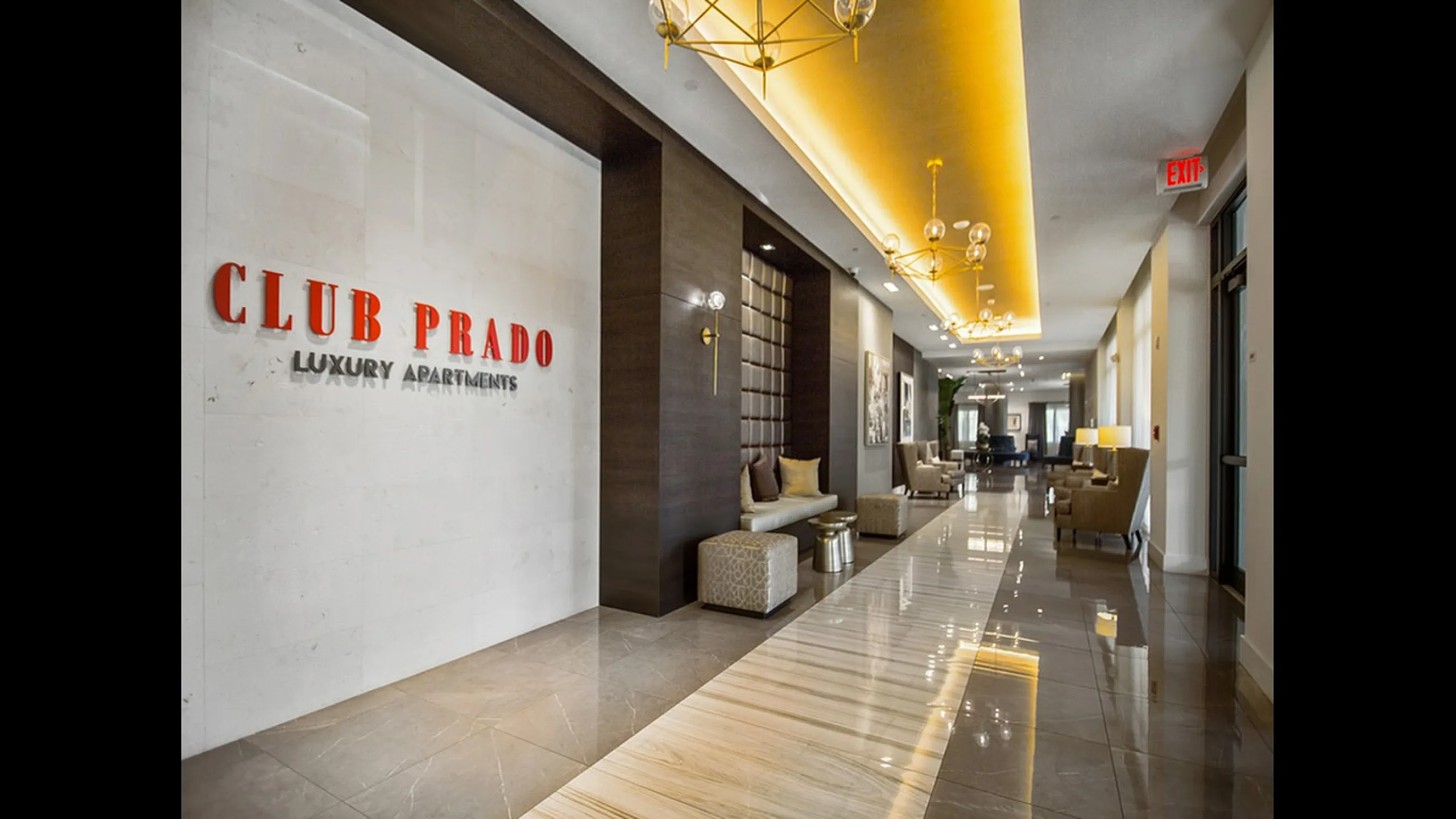 Elegant lobby of Club Prado Luxury Apartments, featuring modern decor, plush seating, and ambient lighting.