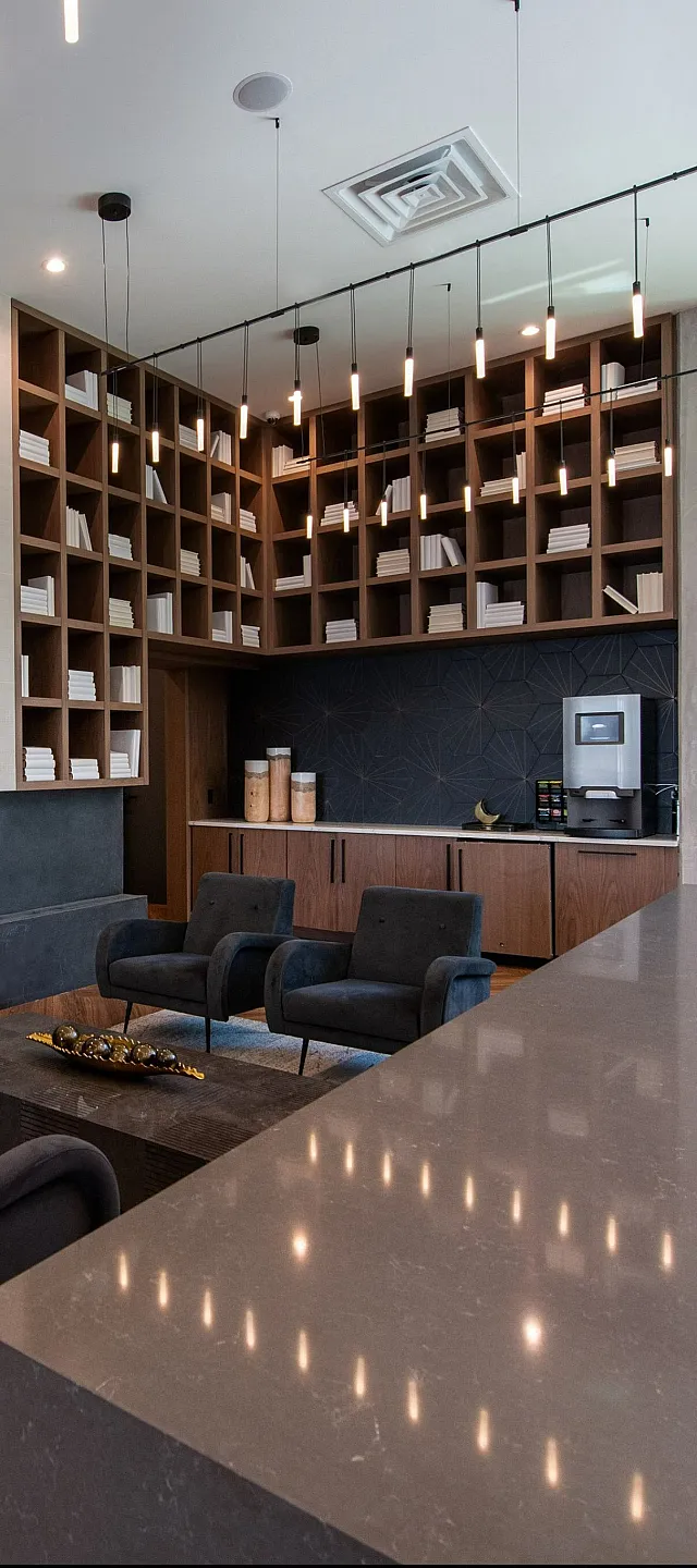 Luxurious and modern lounge with sleek shelving, elegant lighting, and plush seating for a sophisticated atmosphere.
