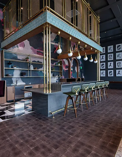 Chic and modern lounge area featuring artistic wall decor, elegant bar stools, and intimate seating spaces.