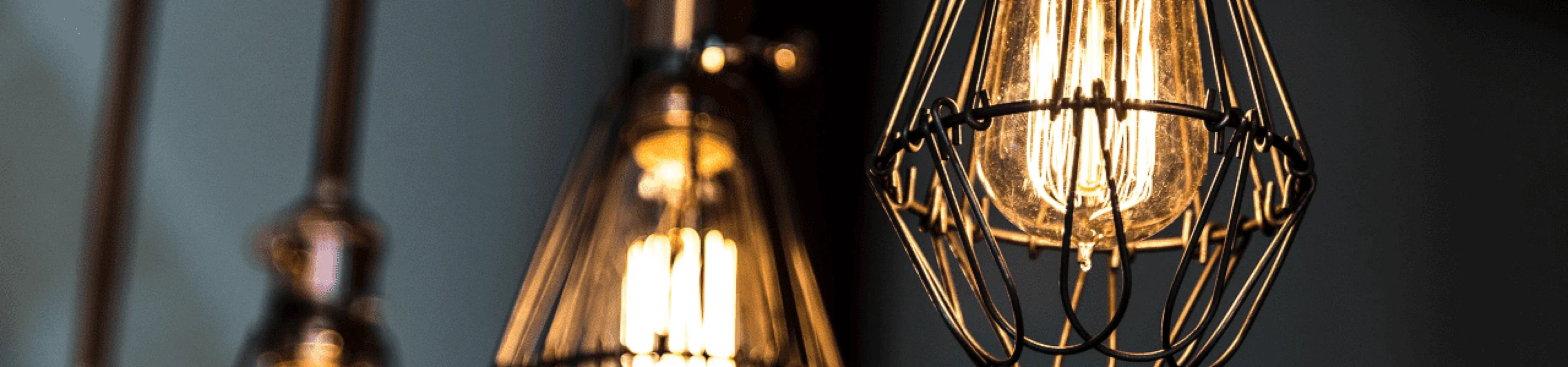 Elegant industrial-style pendant lights with exposed bulbs create a warm, inviting ambiance.