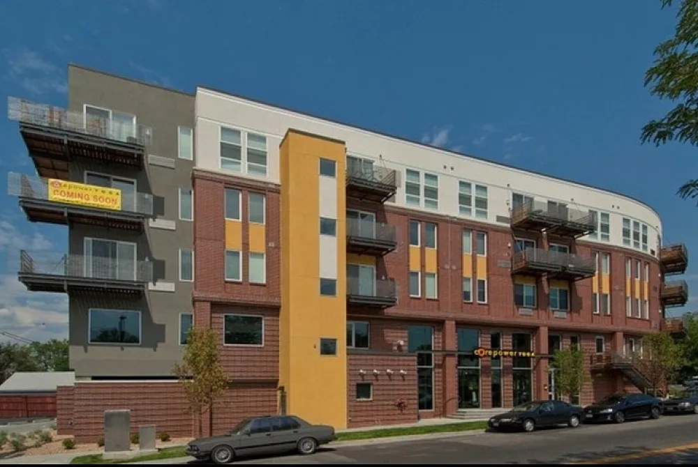 Contemporary apartment building with vibrant architectural design, featuring spacious balconies and a modern facade inviting potential residents.