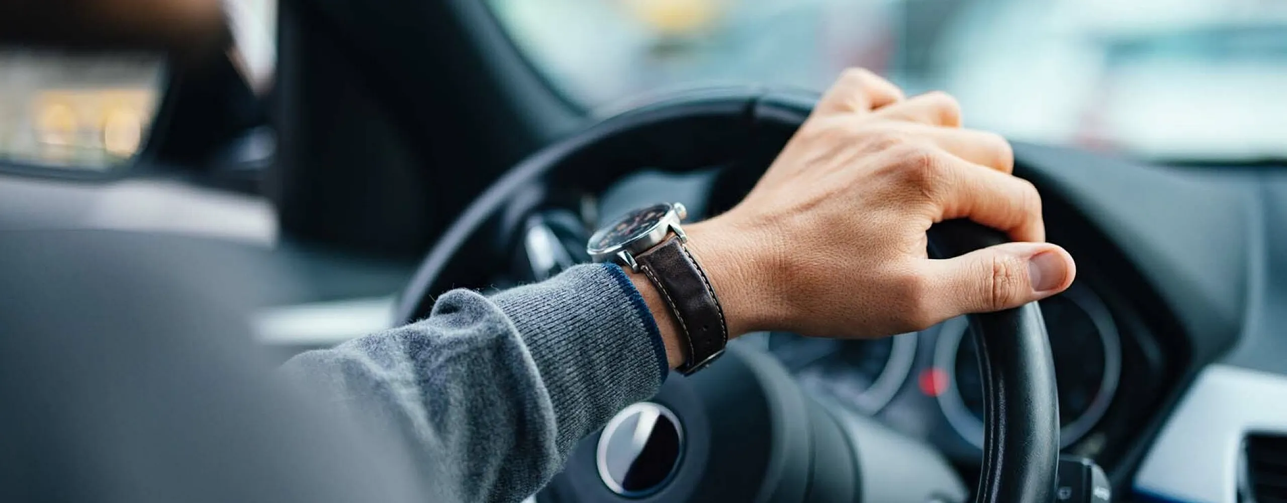 Guy driving car with watch