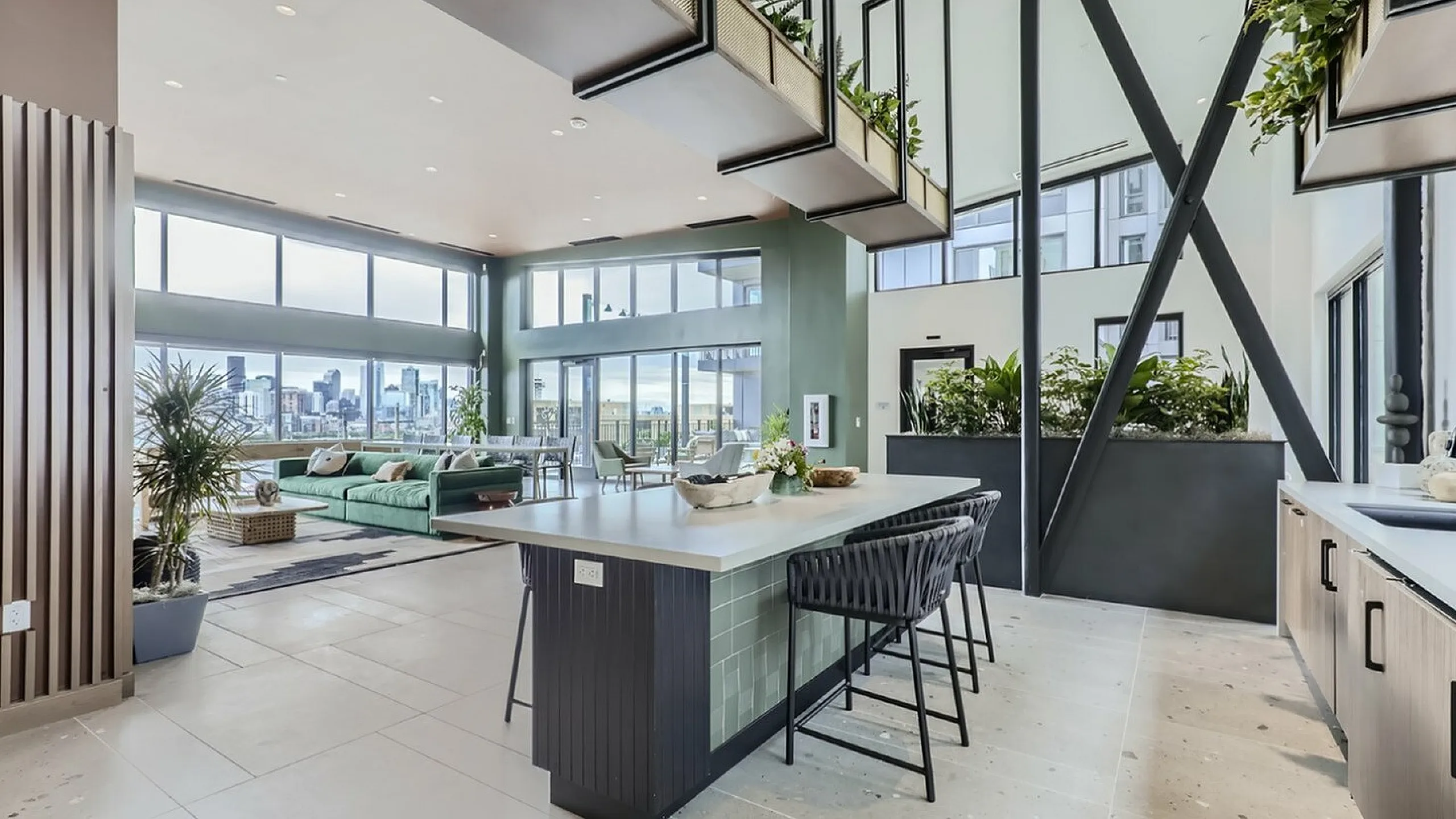 Bright and modern apartment with high ceilings, showcasing an open-concept layout with panoramic city views and lush interior greenery.