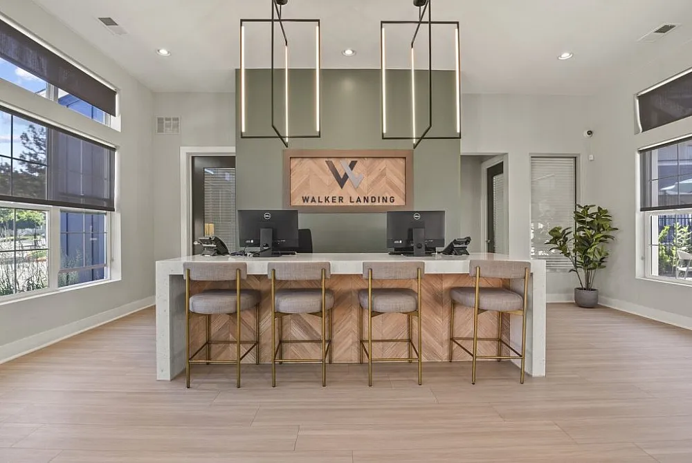 Modern and welcoming office lobby with stylish decor, featuring a contemporary reception desk, elegant chairs, and abundant natural light from large windows.