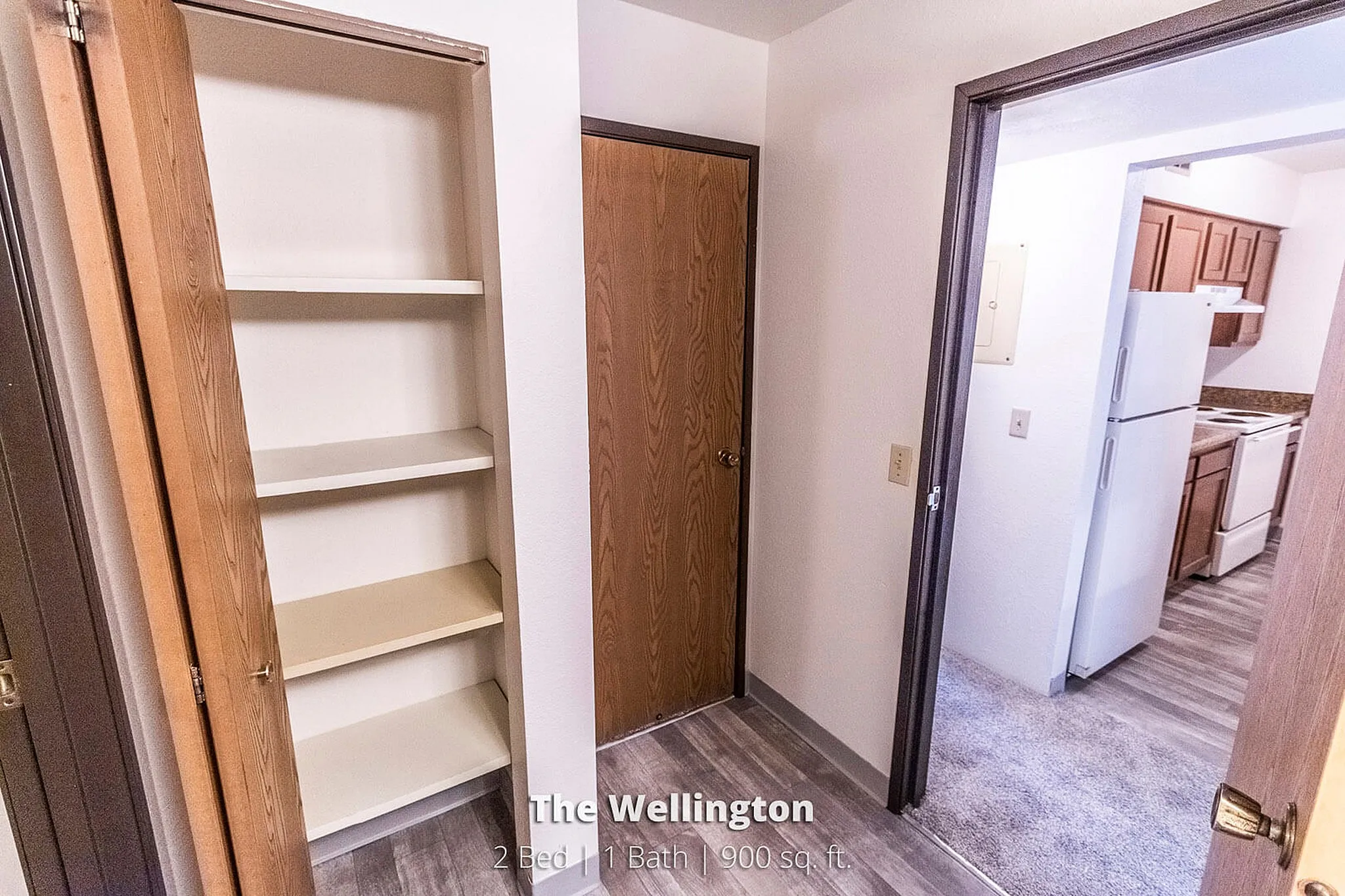 Charming apartment showcasing a spacious kitchen with modern appliances and ample storage space. Featuring The Wellington, a 2 bed, 1 bath layout in 900 sq. ft.