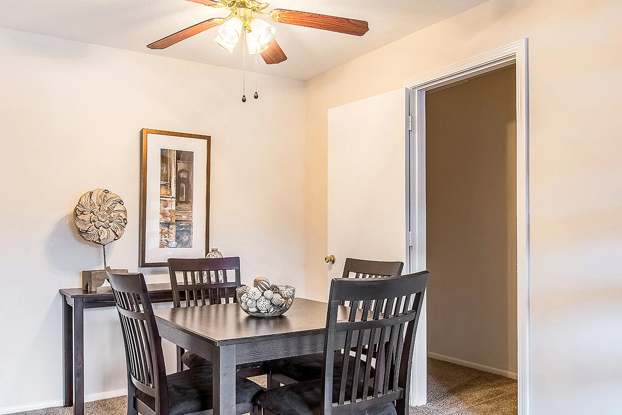 Bright and inviting dining area with elegant dark wood furniture and modern decor, perfect for intimate gatherings.