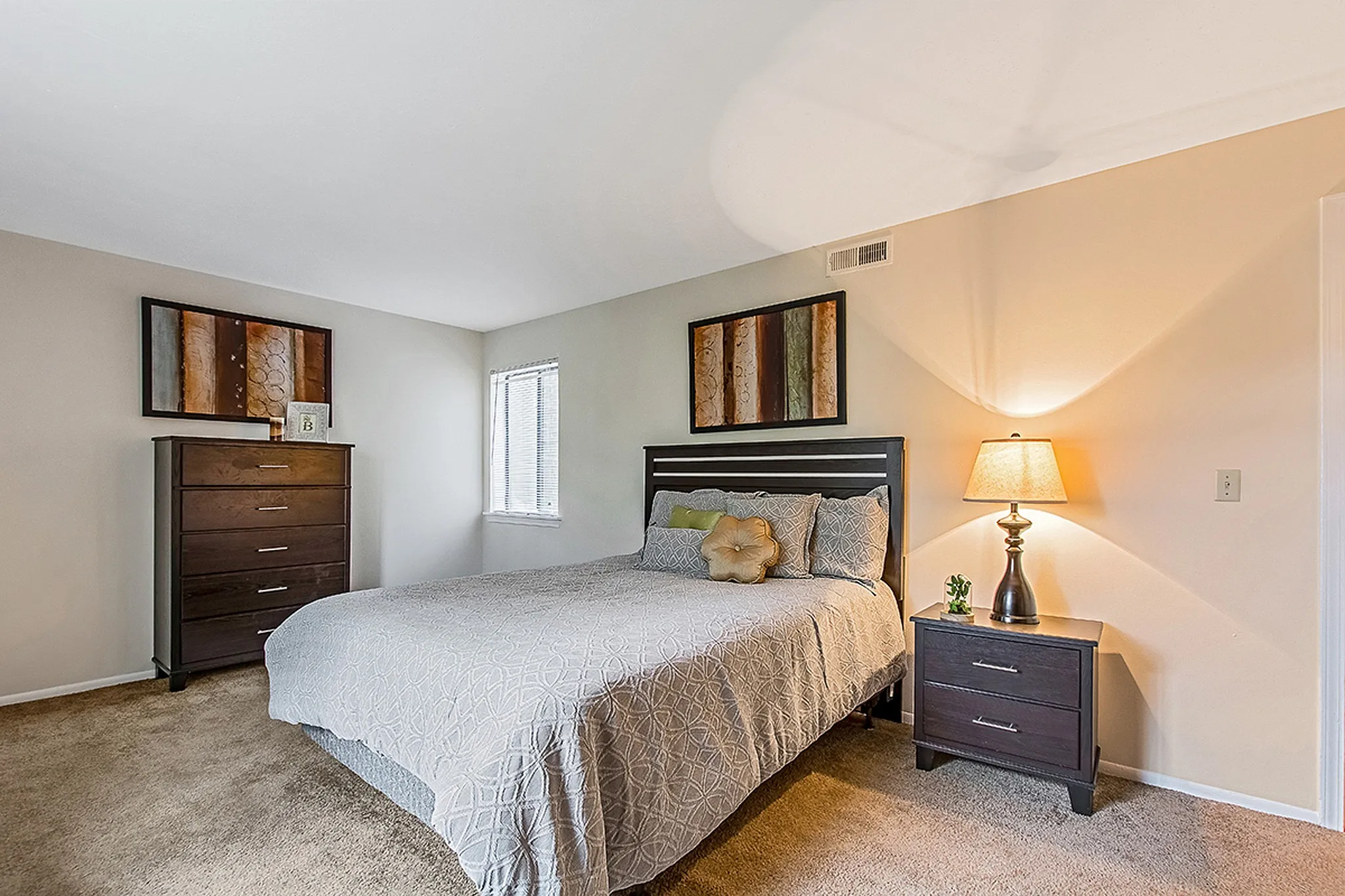 Inviting bedroom with a comfortable bed, stylish decor, and warm lighting creating a cozy ambiance.
