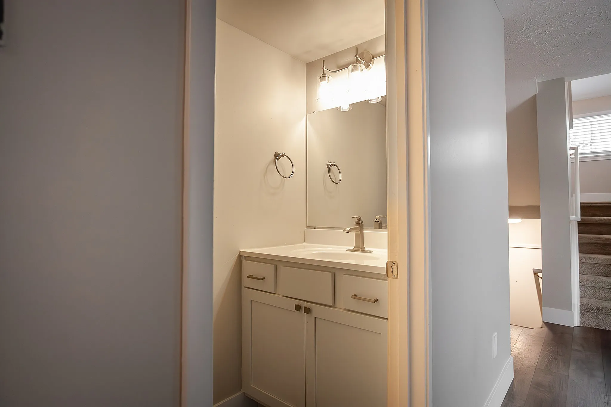 Modern bathroom with sleek fixtures, ample natural light, and elegant mirror reflecting sophistication.