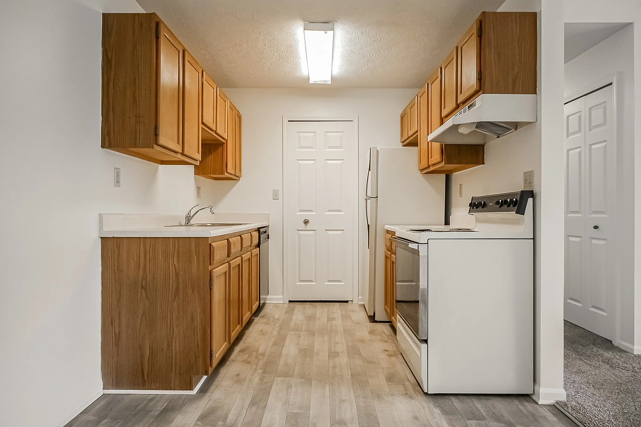 Bright and modern kitchen with wooden cabinetry, sleek countertops, and contemporary appliances, perfect for culinary inspiration.