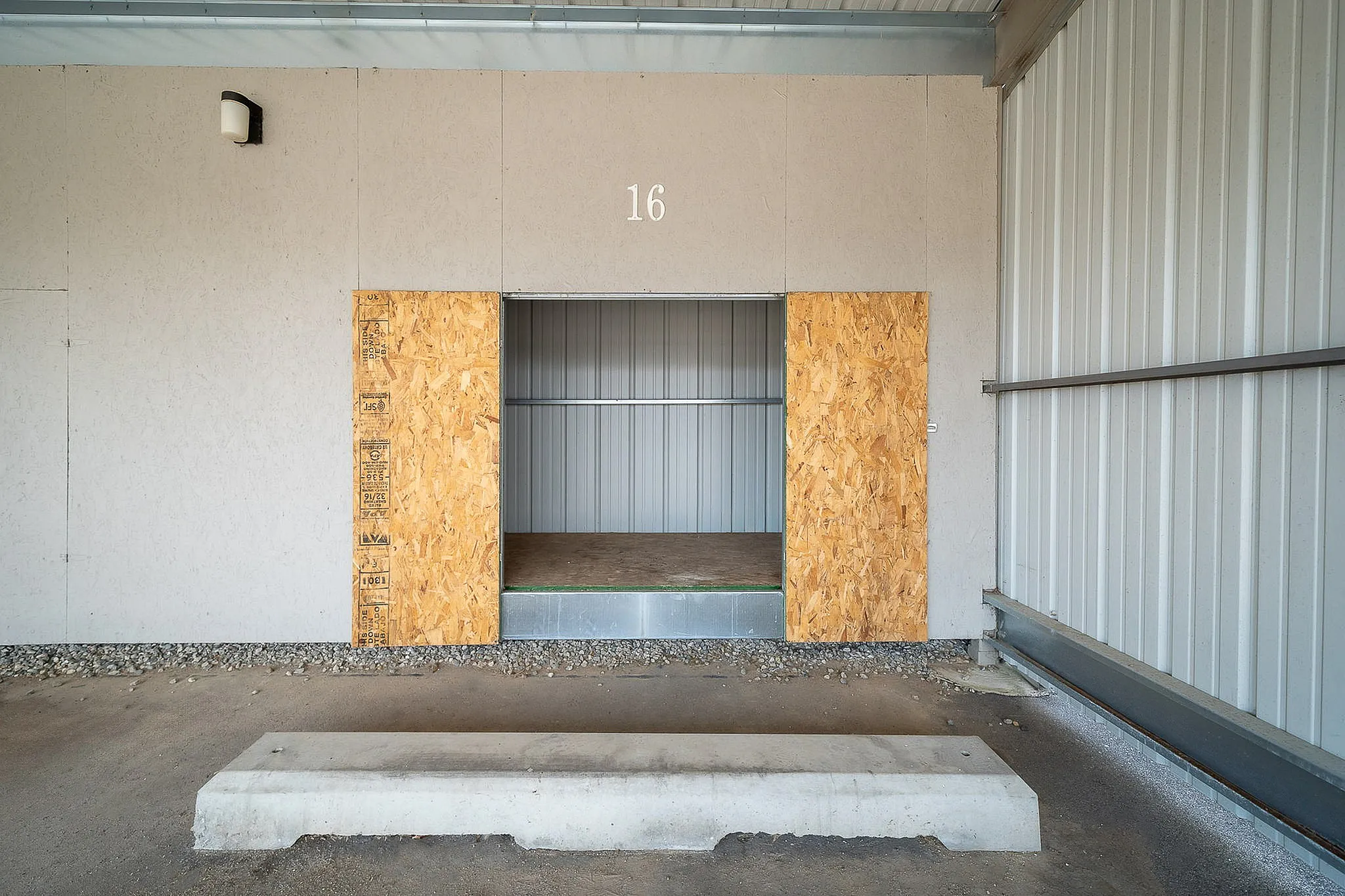 Innovative storage unit with easy access, featuring sleek metal walls and a durable wooden entrance.