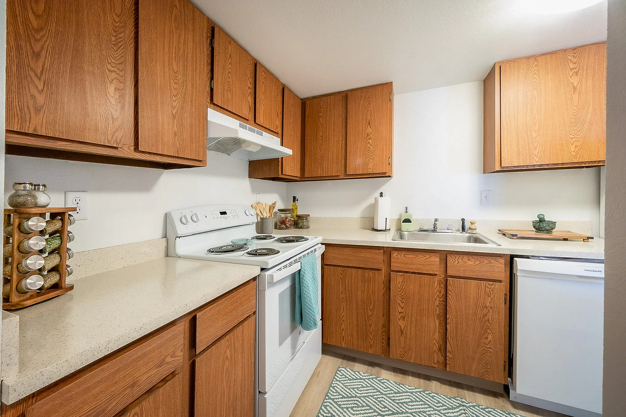 Charming kitchen with warm wooden cabinets, modern appliances, and elegant countertops, perfect for culinary enthusiasts.