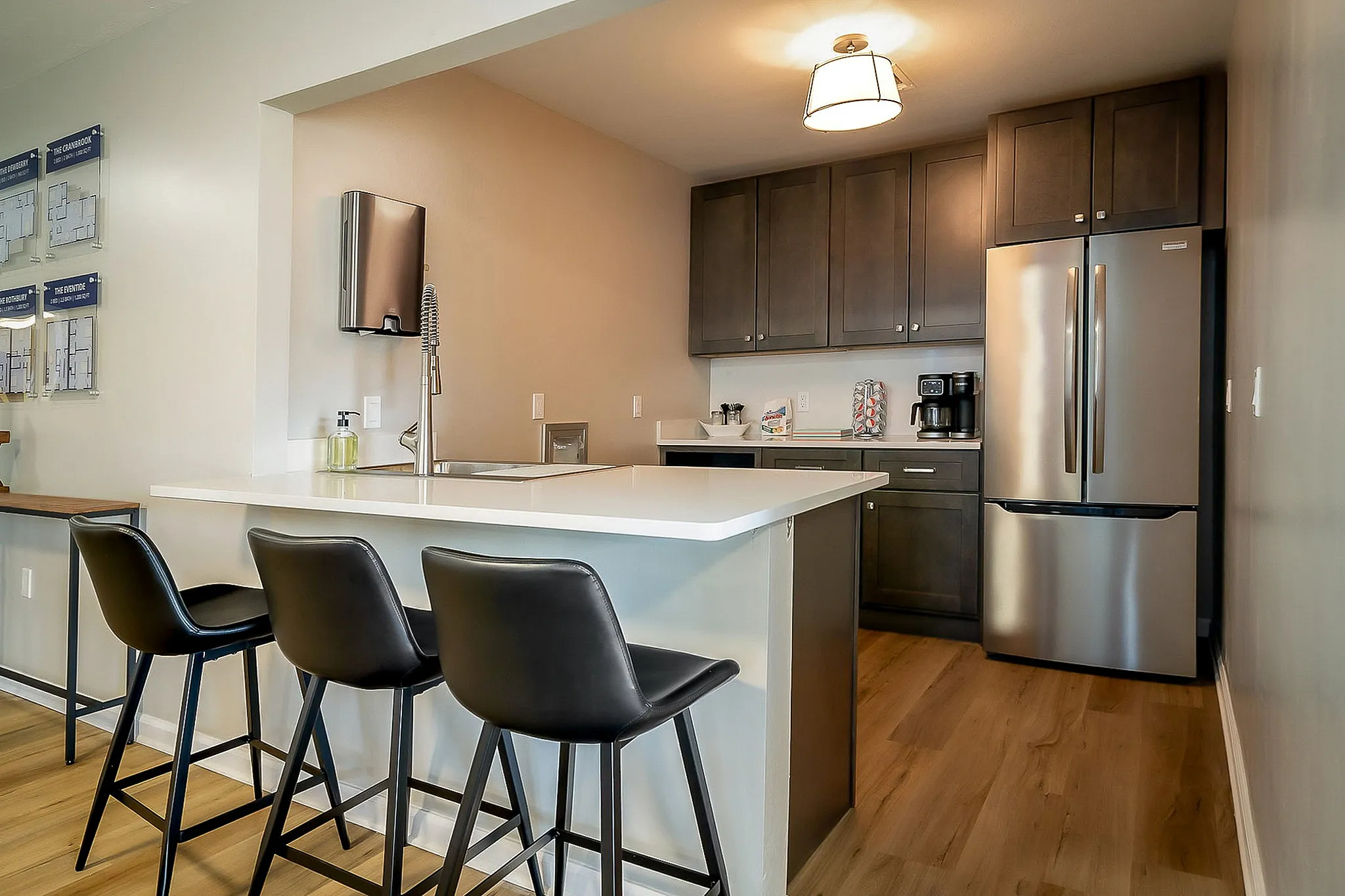 Modern kitchen with sleek stainless steel appliances, elegant cabinetry, and a spacious island with bar seating for comfortable dining.