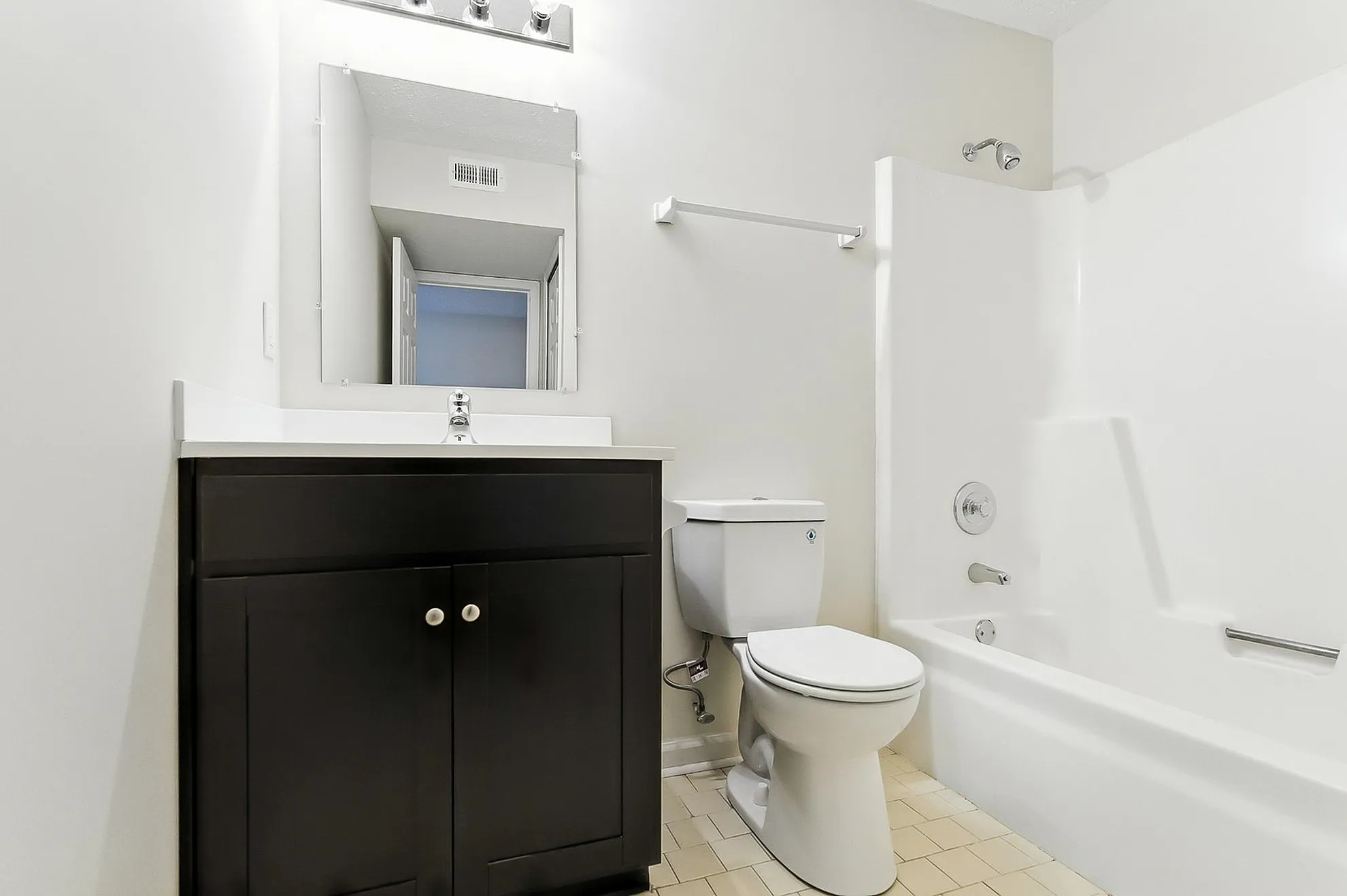 Contemporary bathroom with sleek vanity and modern shower in bright, minimalist design.