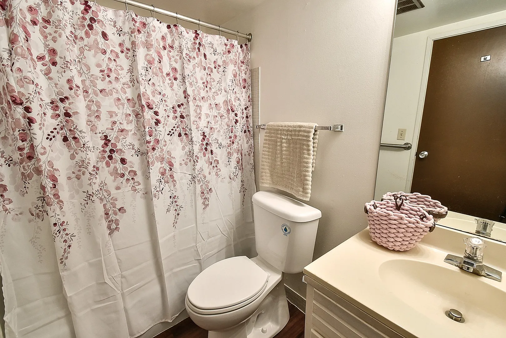 Charming bathroom with elegant floral shower curtain and modern fixtures.
