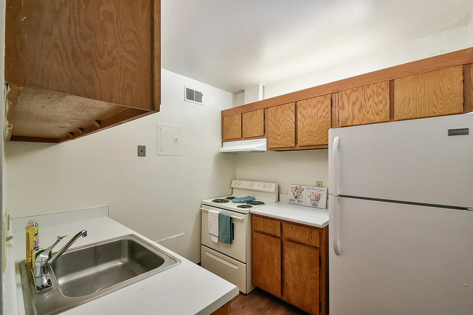 Charming kitchen with warm wooden cabinets, modern appliances, and a cozy, inviting layout.