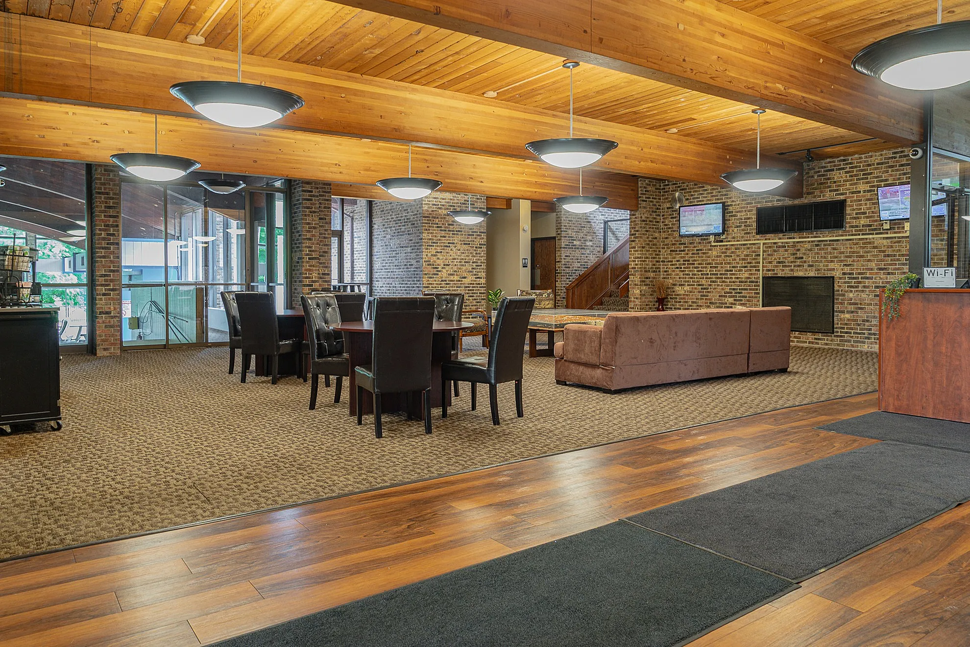 Elegant community lounge with warm brick accents, cozy seating, and inviting ambient lighting.