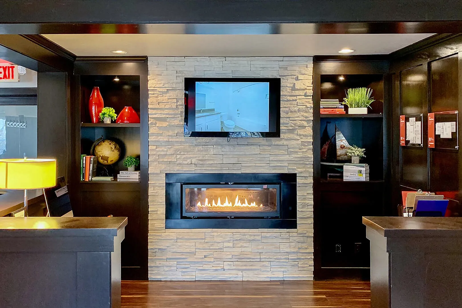 Luxurious living room showcasing a modern fireplace, sleek built-in shelves with decor, and a stylish TV display.