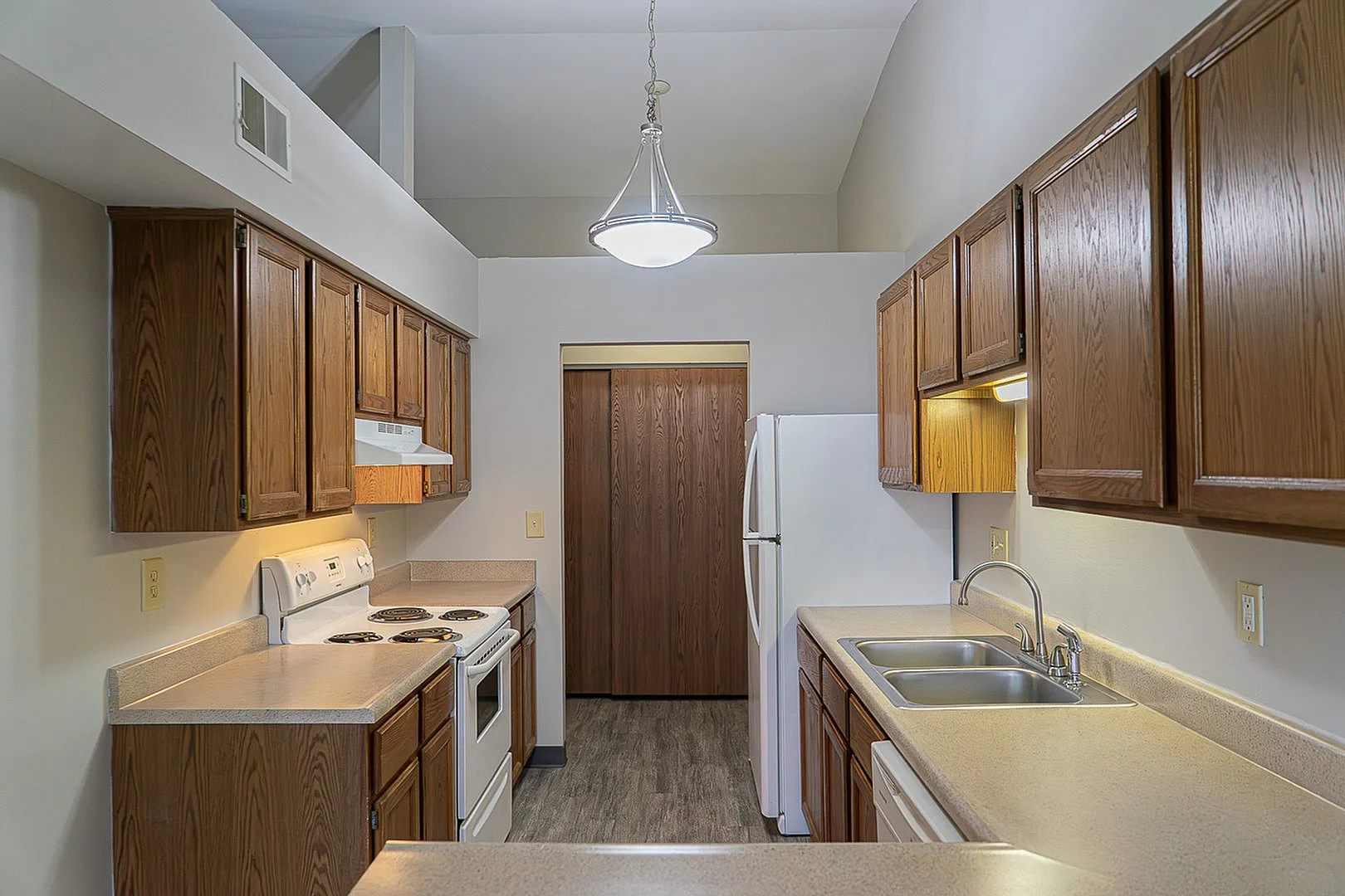 Contemporary kitchen with warm wooden cabinetry, sleek countertops, and modern appliances, perfect for culinary creativity.