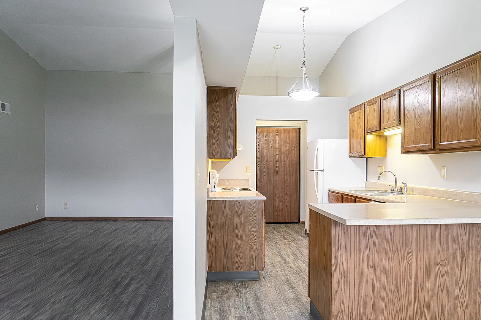 Contemporary kitchen with elegant wood cabinets, sleek countertops, and open floor plan perfect for modern living.