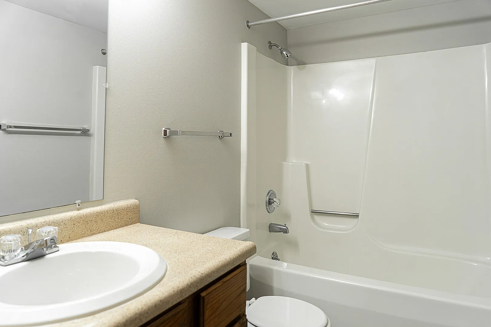 Bright and elegant bathroom featuring a sleek modern sink, polished countertop, and a pristine bathtub.