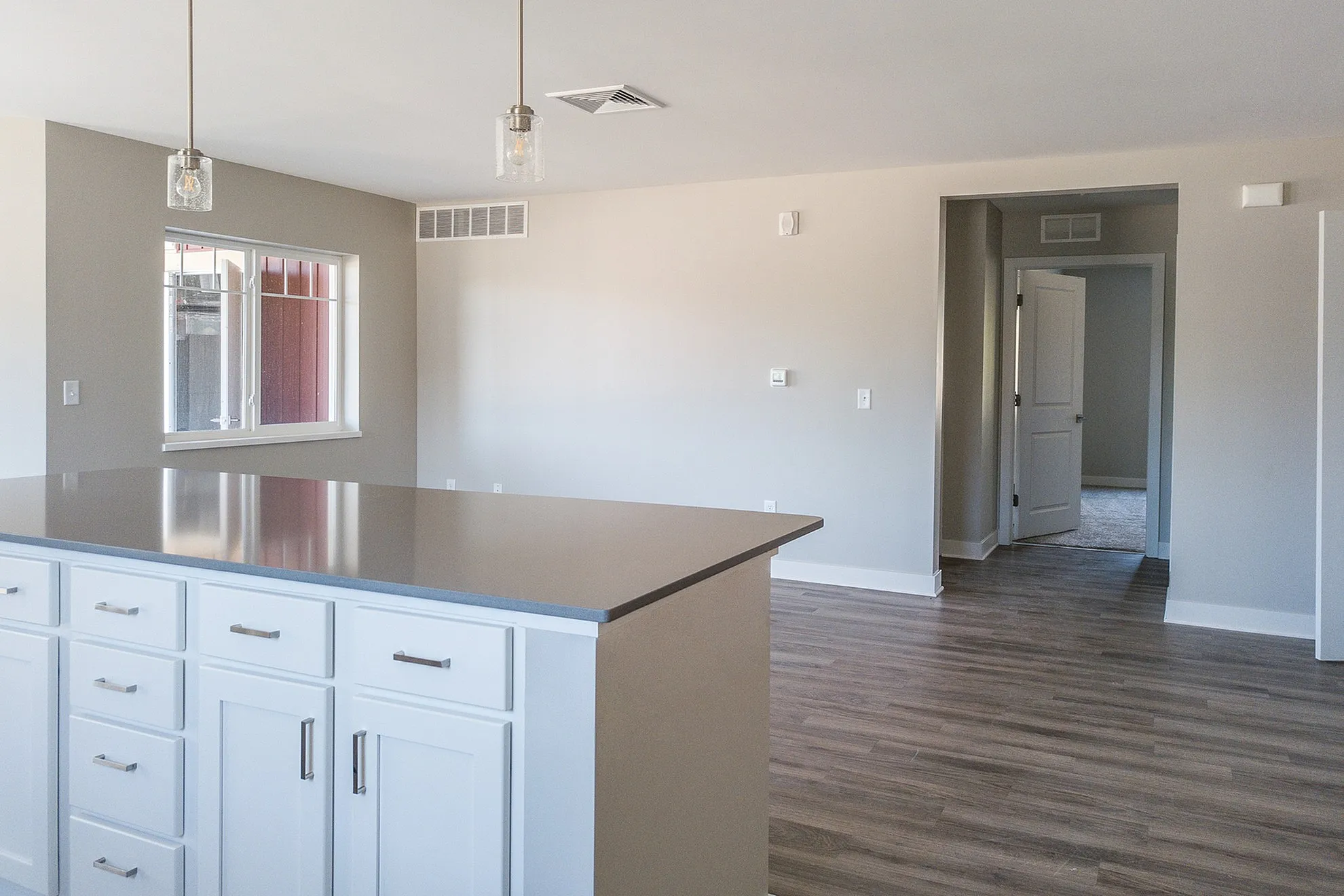 Bright, modern kitchen with sleek island, ample storage, and stylish pendant lights in a spacious open-concept layout.