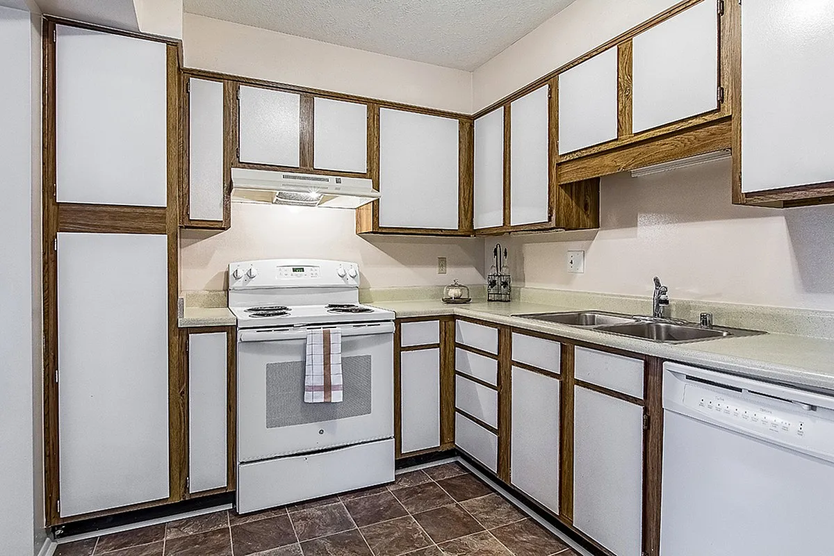 Charming kitchen with classic cabinetry, modern appliances, and a double sink, perfect for culinary enthusiasts.