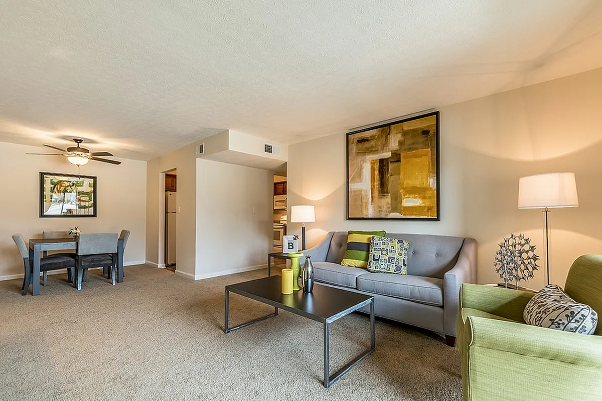 Bright and inviting living room with modern decor, comfortable seating, and an open dining area, perfect for relaxation and entertaining.