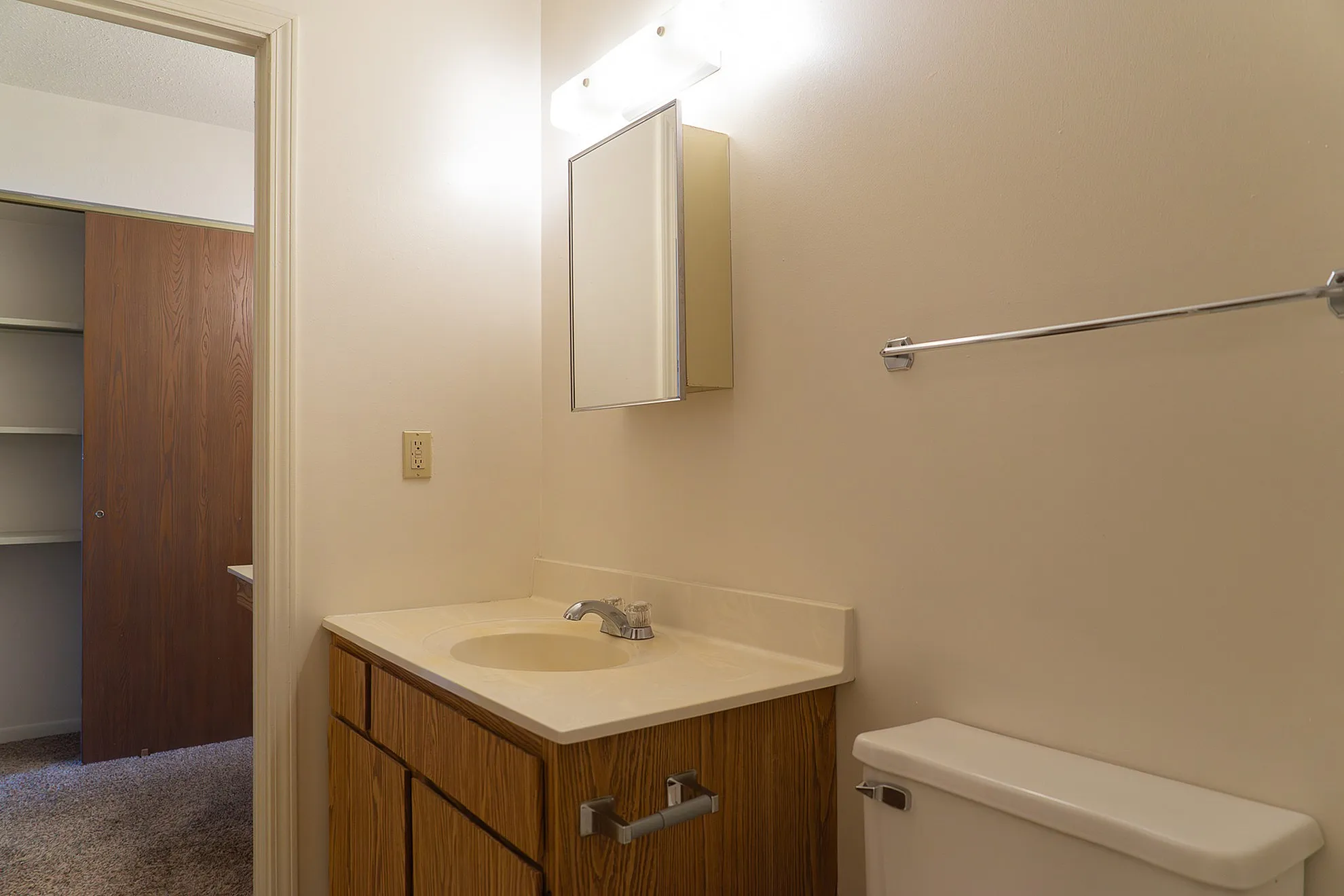 Elegant bathroom with a sleek vanity, large mirror, and a tranquil ambiance, perfect for relaxation and rejuvenation.