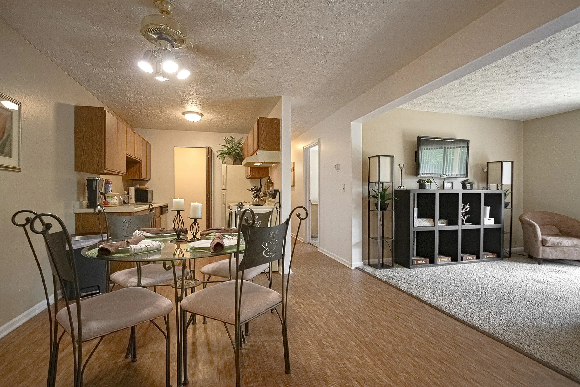 Inviting open-concept apartment with a cozy dining area and a warm, welcoming living room, perfect for relaxation and entertaining.