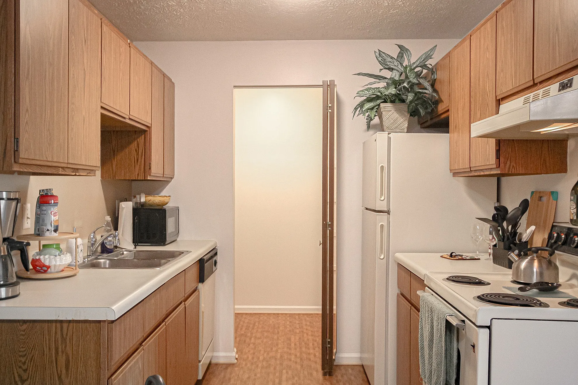 Charming and functional kitchen with wooden cabinets, elegant countertops, and modern appliances, perfect for culinary enthusiasts.