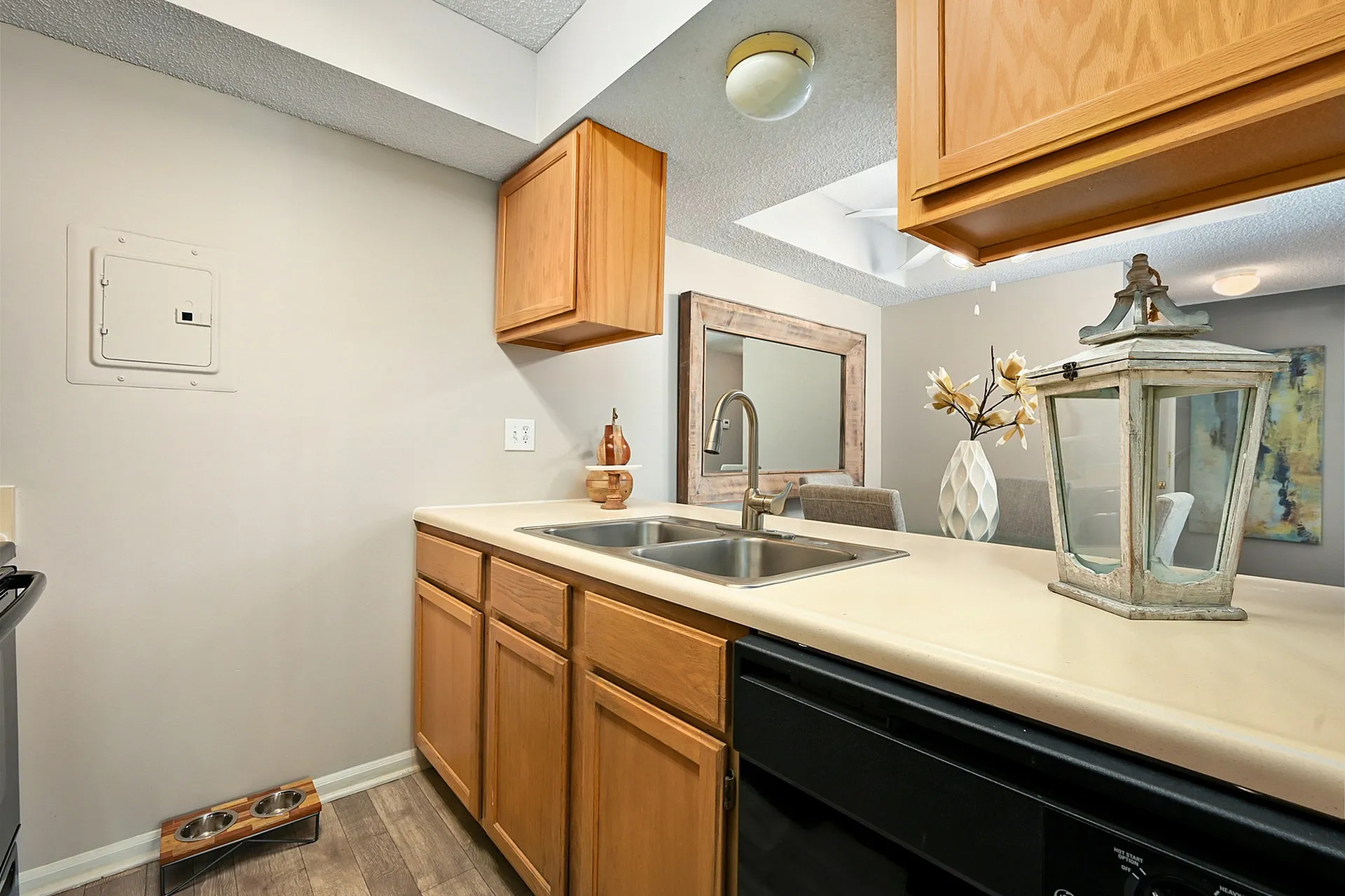 Charming kitchen with sleek countertops, double sink, and elegant wooden cabinetry, offering a warm and inviting space for culinary adventures.