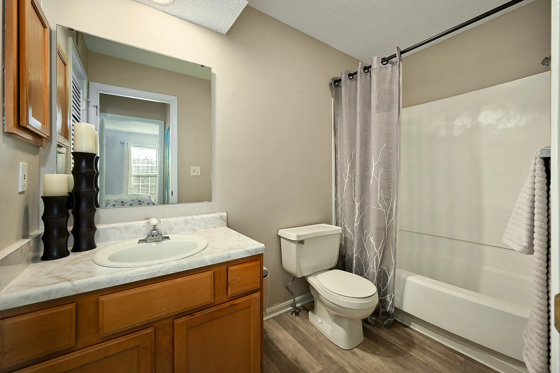 Modern bathroom featuring elegant fixtures, sleek countertops, and a stylish shower curtain, offering a refreshing and calming space.