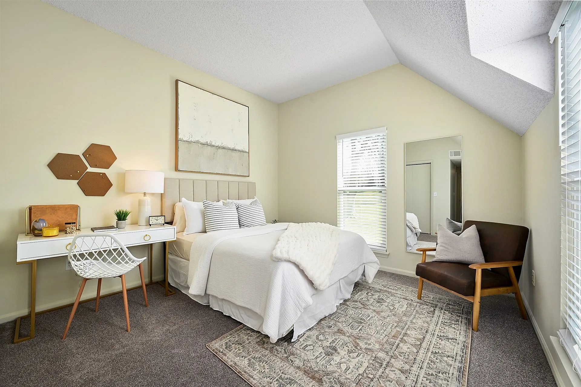 Cozy and stylish bedroom with modern decor, featuring a comfortable bed, elegant desk, and natural lighting for a serene ambiance.