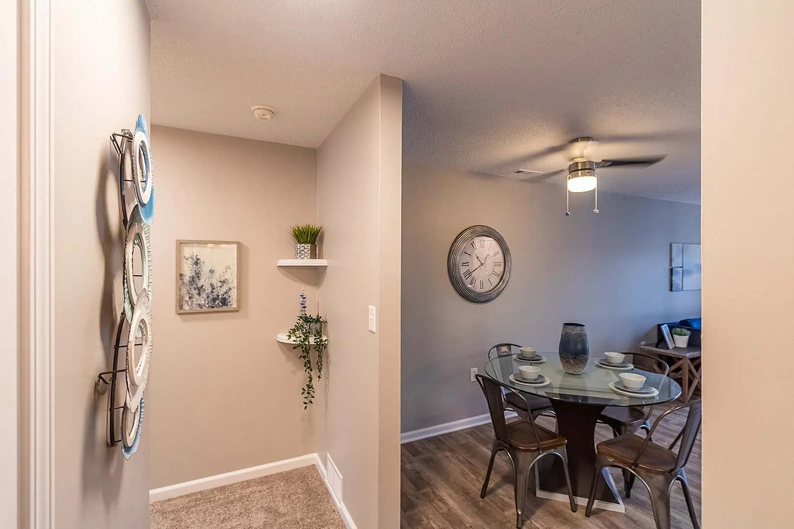 Charming hallway leading to a cozy dining area with modern decor, soft lighting, and stylish wall accents.