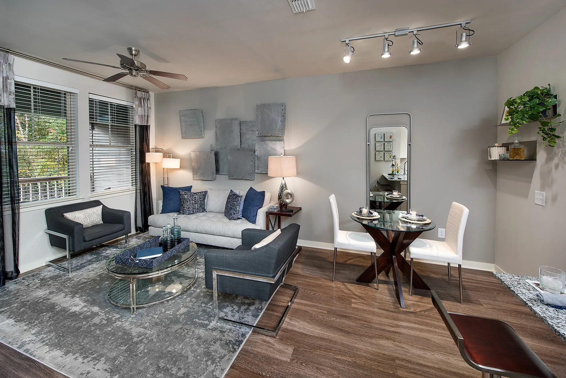 Chic and modern living room with elegant furniture, stylish rug, and ambient lighting in a contemporary apartment setting.