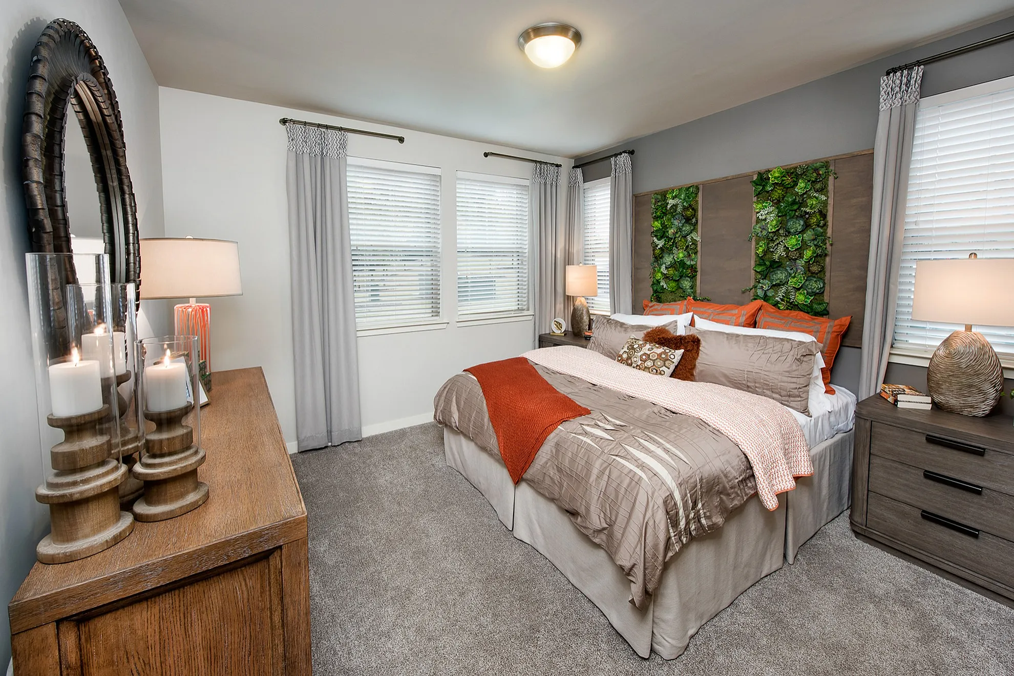 Cozy bedroom featuring elegant decor with a plush bed, soft carpets, ambient lighting, and modern wooden furnishings.
