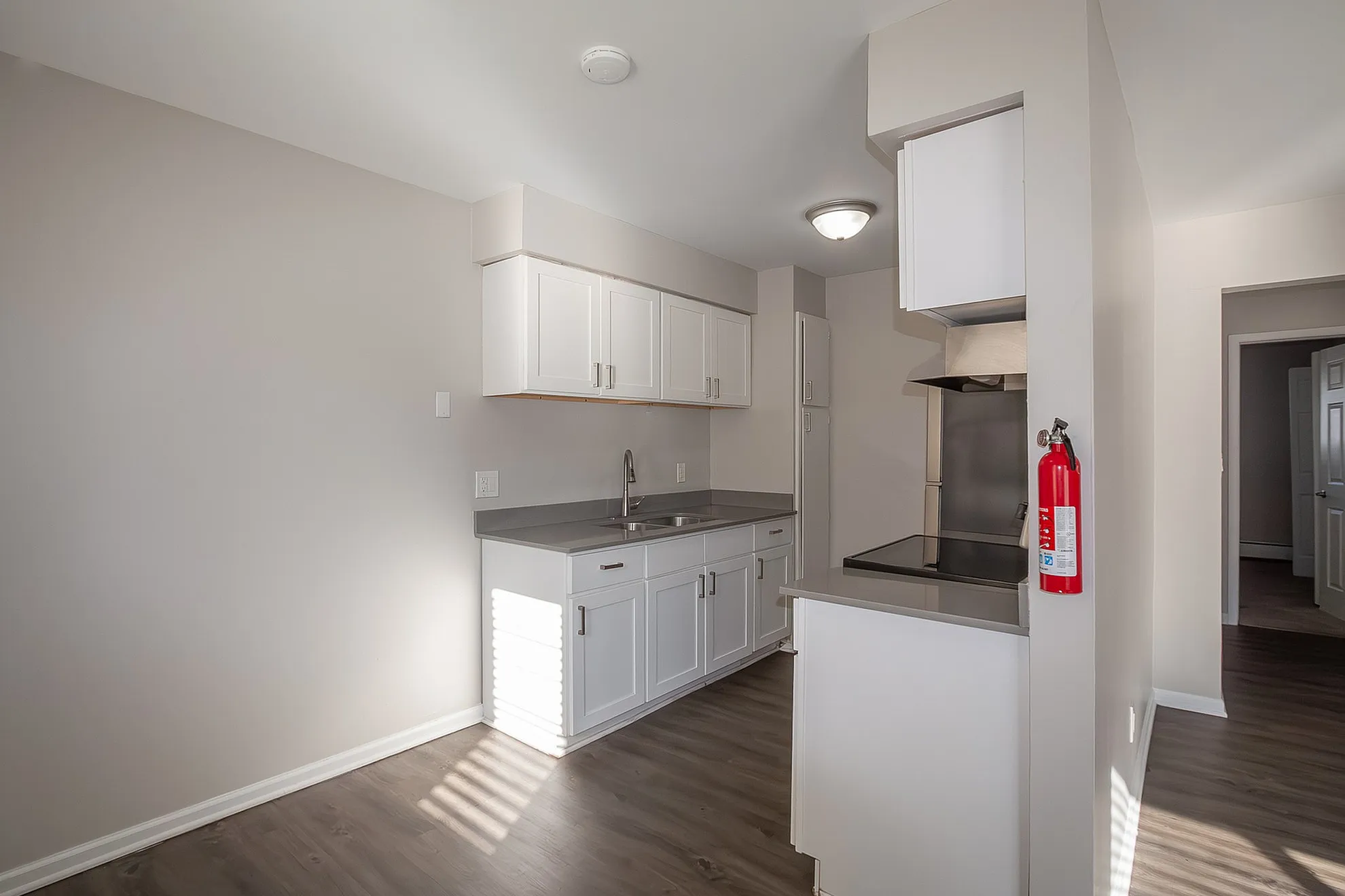 Elegant kitchen with sleek white cabinetry, modern stainless steel appliances, and abundant natural light.
